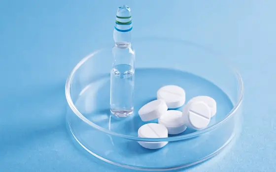 Close-up view of pills in a laboratory dish inside a pharmaceutical lab.