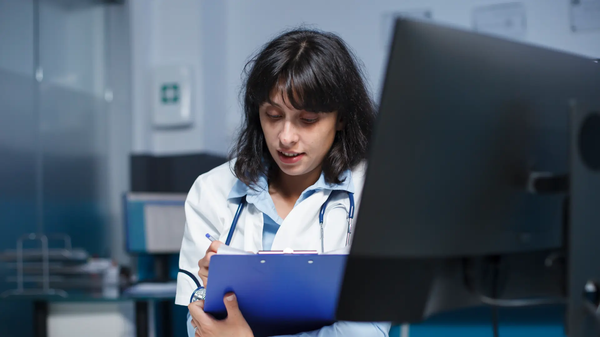 doctor-reviewing-ai-brain-scan-analytics-on-multiple-screens