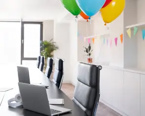 Overhead view of a diverse team engaged in a brainstorming session, pointing at project strategy maps and documents on a table.