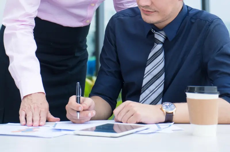 Experienced female medical professional or doctor working on a laptop in a clinic or specialized medical office.